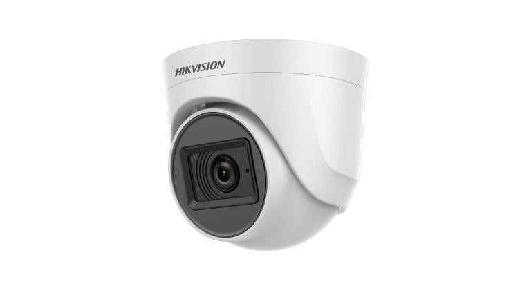 a camera mounted on a wall with a white background