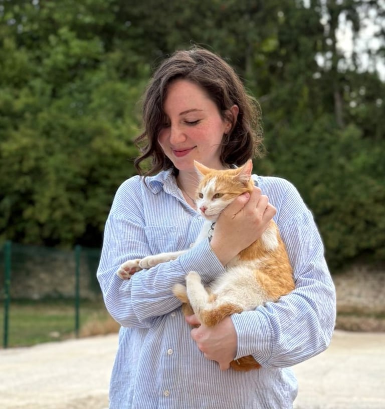 a woman holding a cat in her arms