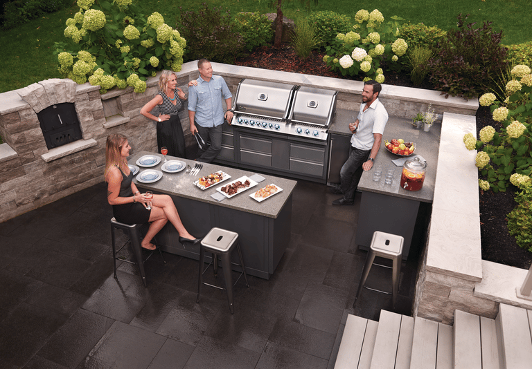 Friends enjoying a luxury napoleon Oasis outdoor kitchen