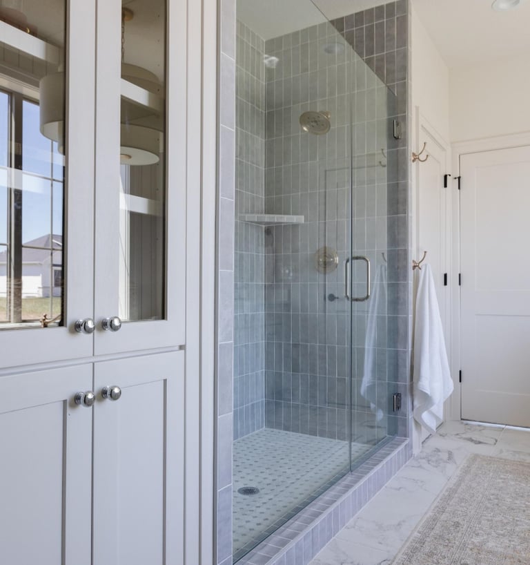 Blue tiled frameless shower enclosure, premium shower repair