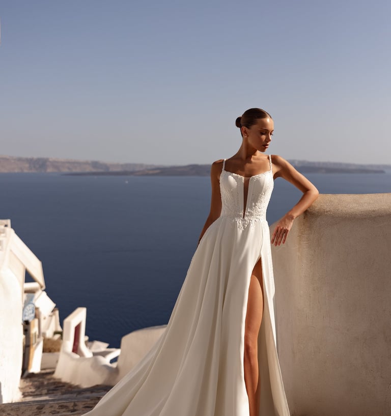 a woman in a white dress standing on a balcony