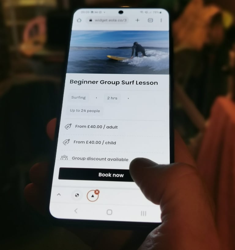A mobile phone displaying a booking page with someone clicking book now