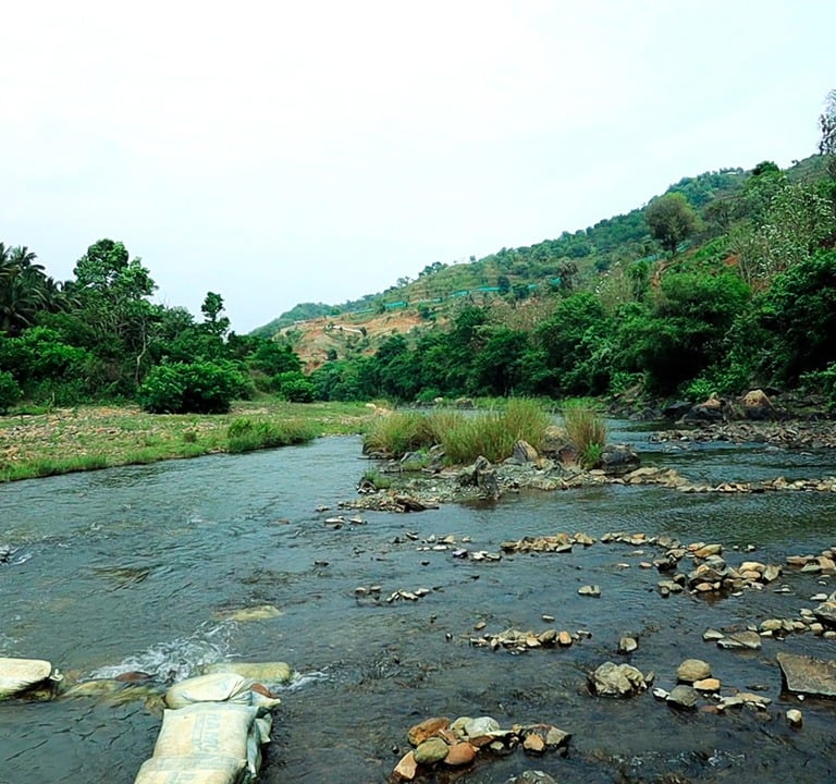 a river with rocks and rocks in the foreground