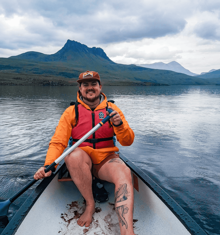 sam rayes creative smiling whilst paddling on a lake