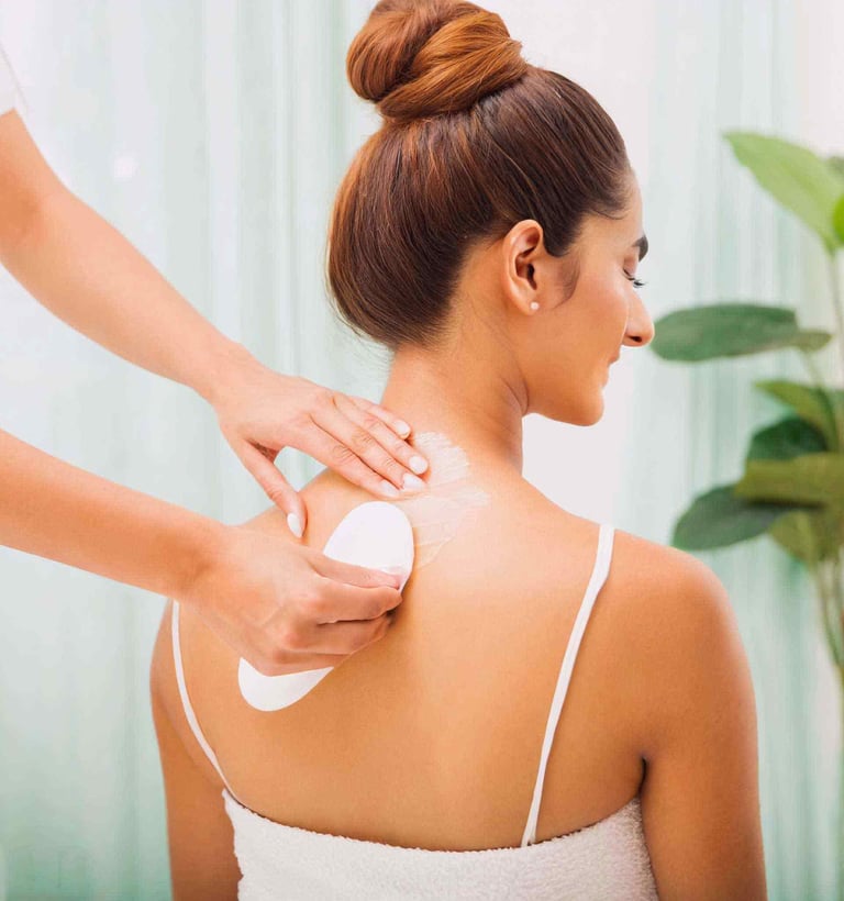 a woman is getting her full body waxed at a salon