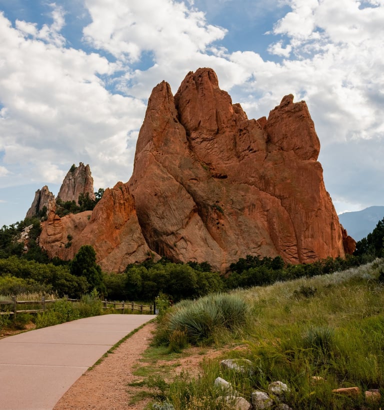 a paved path with a paved path leading to a mountain, Garden of the Gods