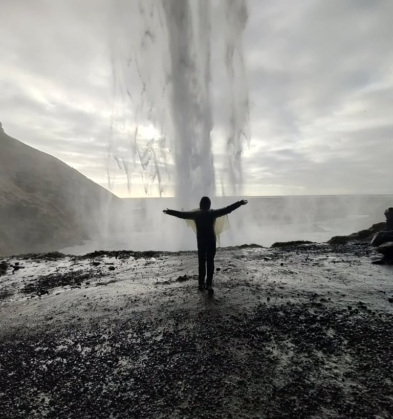 a person standing in front of a waterfall