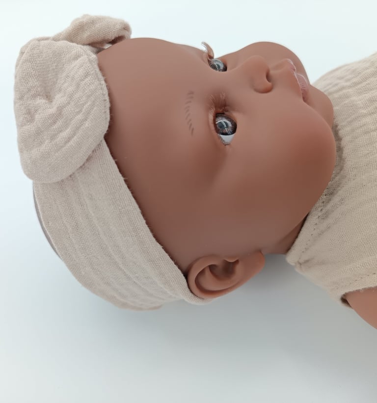 Minikane doll Augustine wearing headband