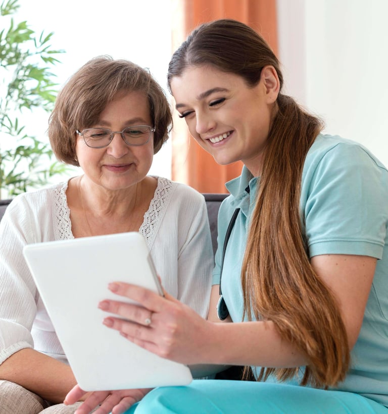nurse and patient smiling while nurse is helping patient