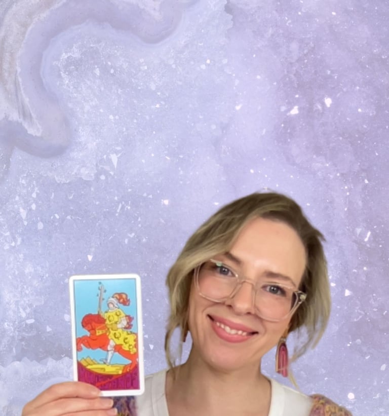 Natalie Grace, Founder of Crystal Aura Tarot, holding the Knight of Wands tarot card