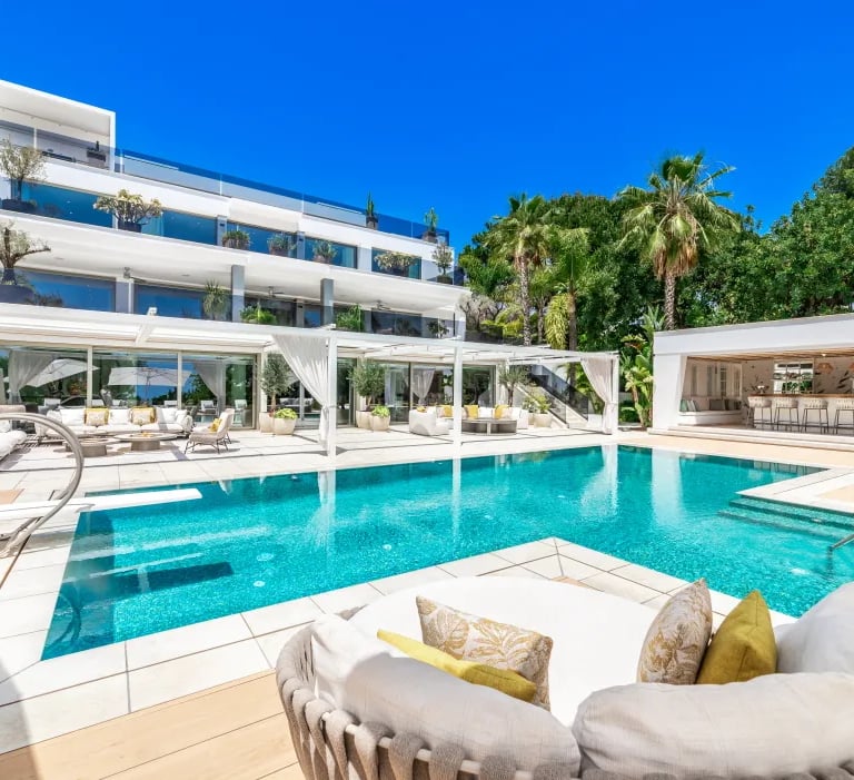 Luxury poolside view of Villa Serenity with palm gardens