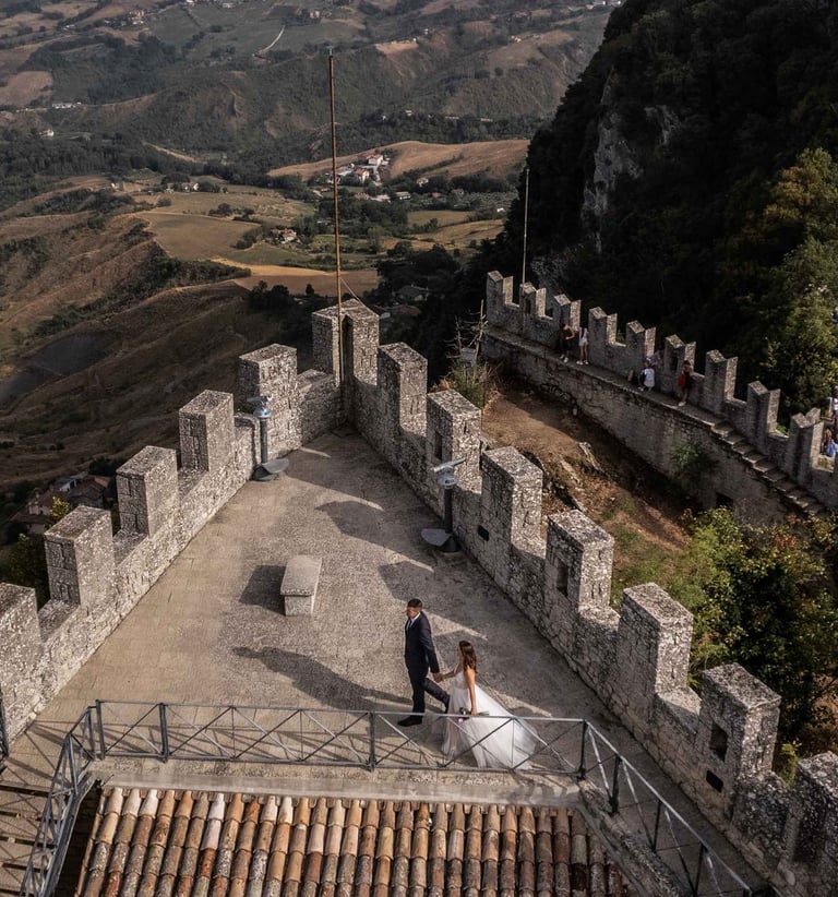 a couple of people standing on a hill top