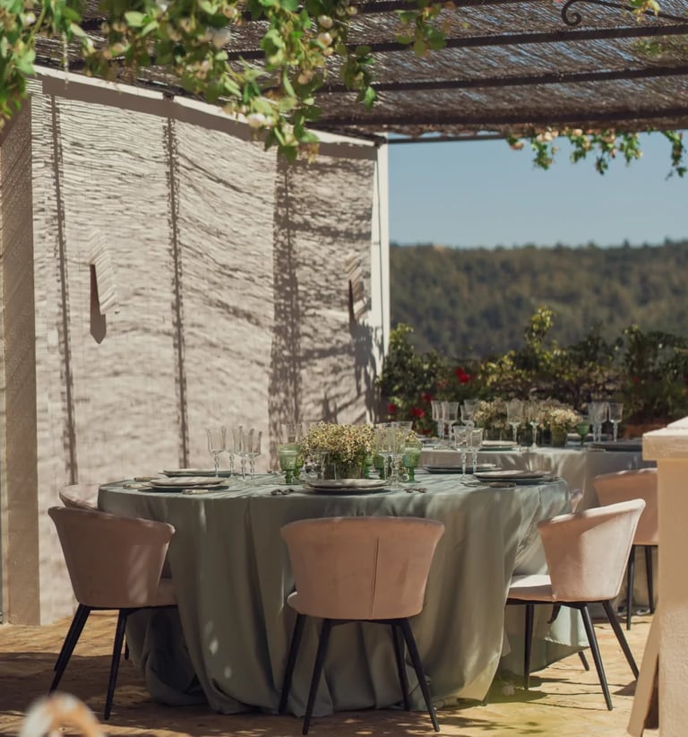 Outdoor dining table under vines at Finca Santa Katerina