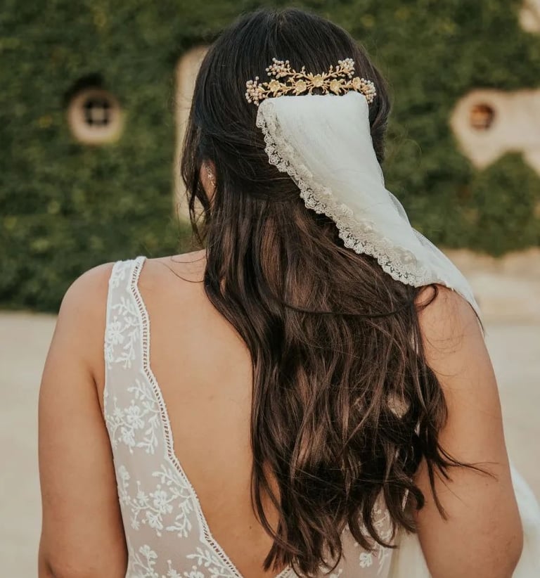 Bride wearing hair accessory and white veil styled by letshair