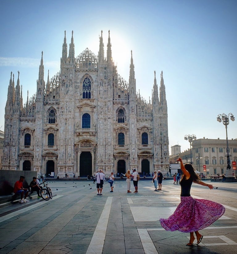 Woman twirling in front of the Duomo di MIlano