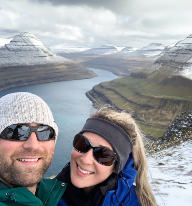 A smiling couple with a mountain vista behind them