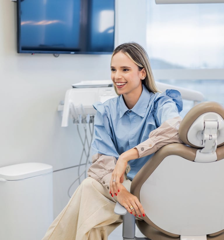 a woman in a dental chair with a smile on her face