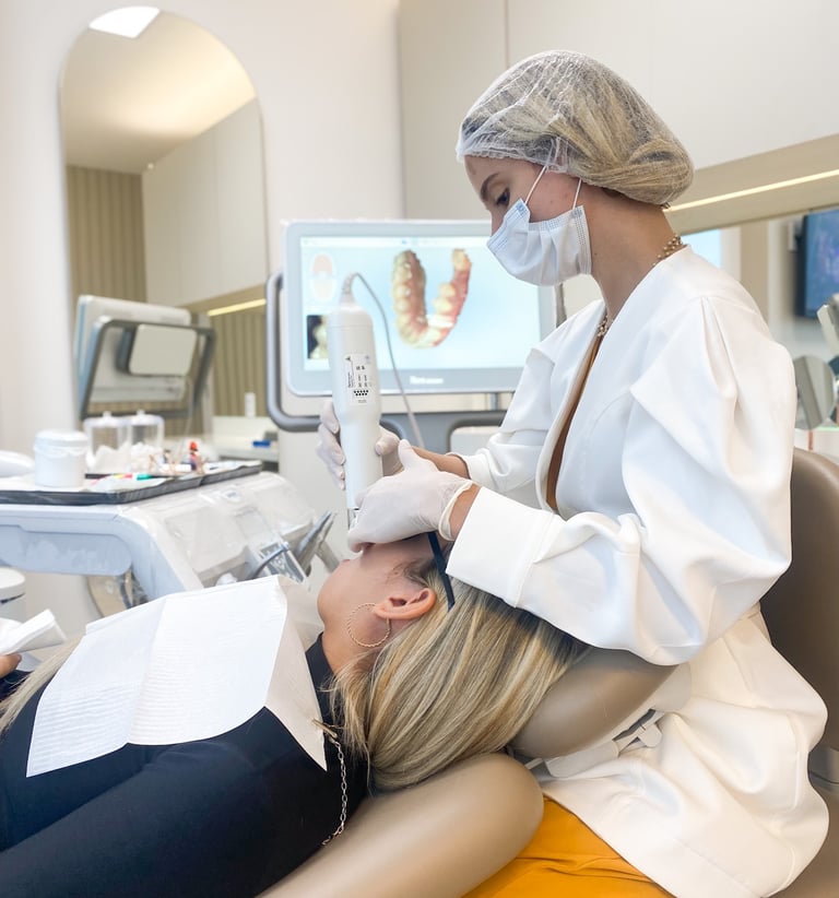 a woman dentist is sitting in a chair in a dental room attending a patient