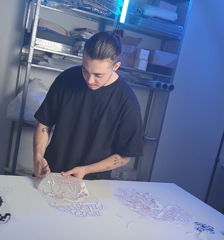 a man in a black shirt is cutting paper with scissors