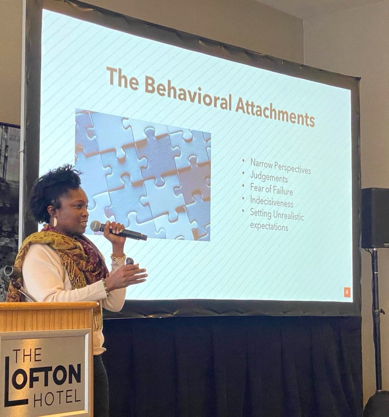 Beatrice Adenodi speaks to a group of professionals at The Lofton Hotel