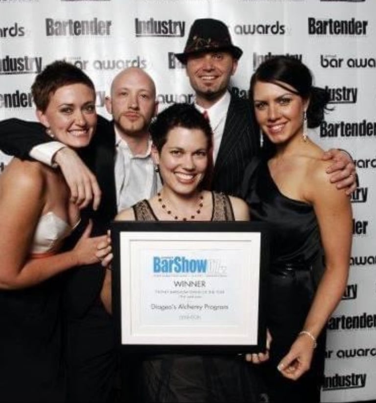 a group of people posing for a photo, they won an award