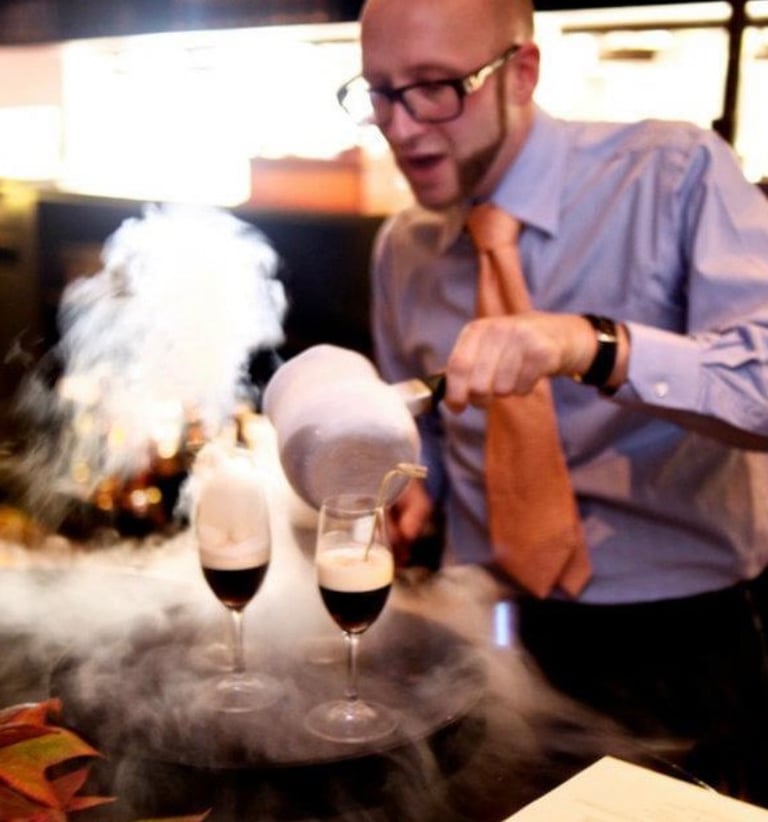 a man in a tie and shirt making molecular cocktails