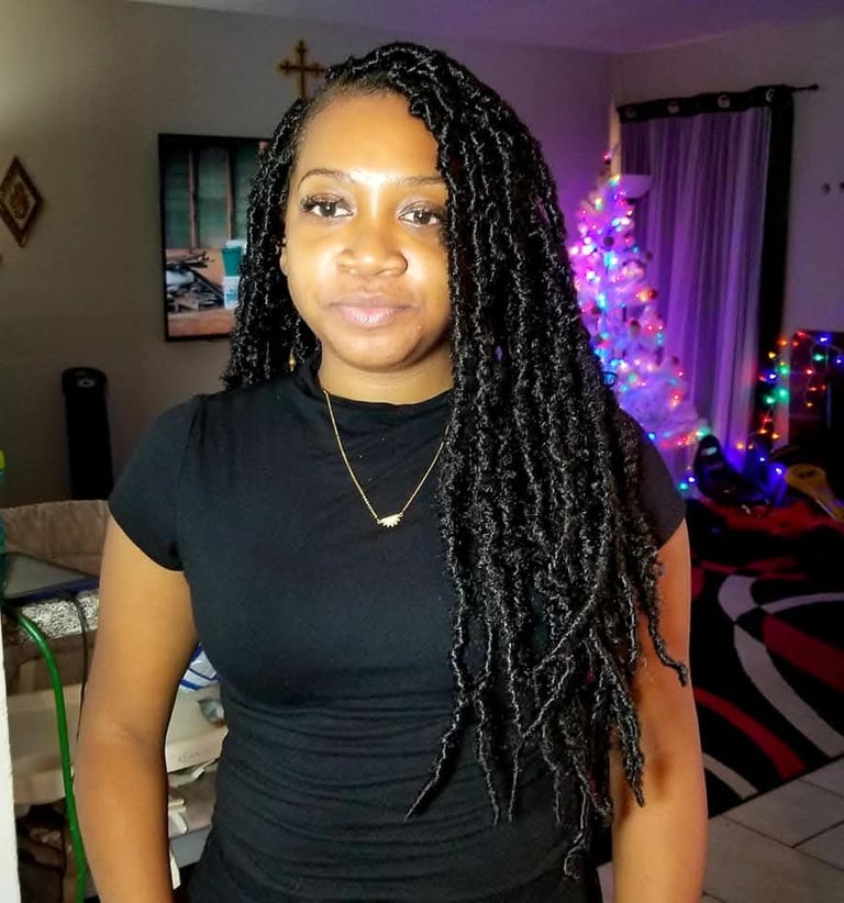 a woman with long black locs 