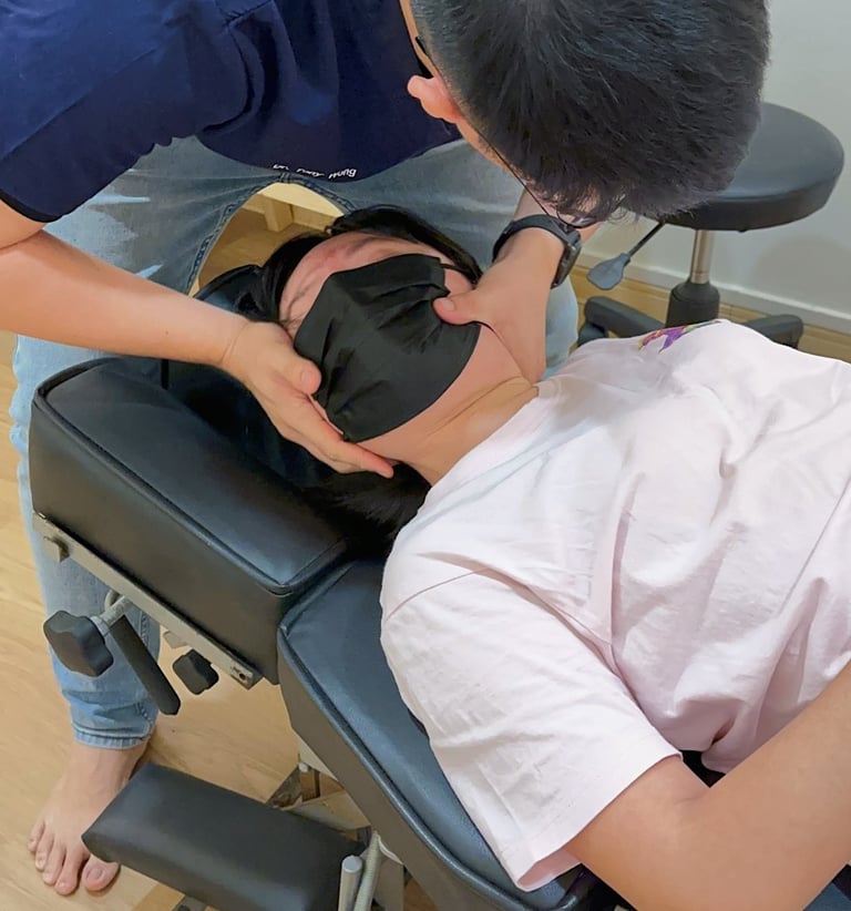 Chiropractor performing neck adjustment for pain relief at Sinisana Chiropractic