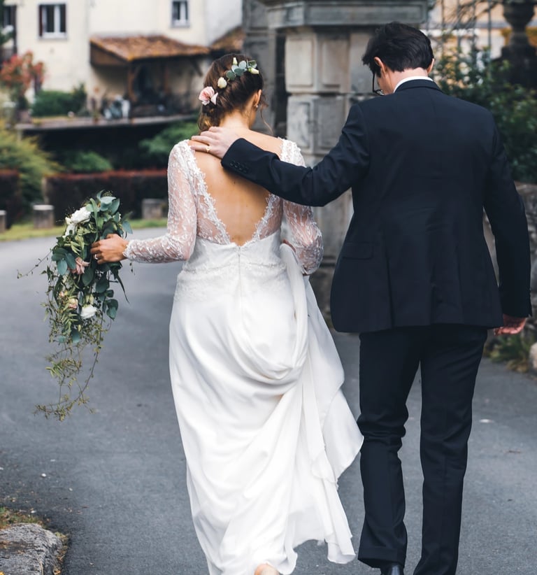 Couple de jeunes mariés de dos qui marchent ensemble