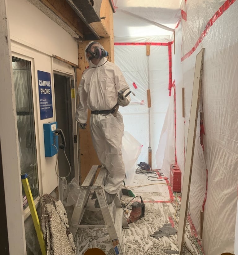 abatement worker removing asbestos