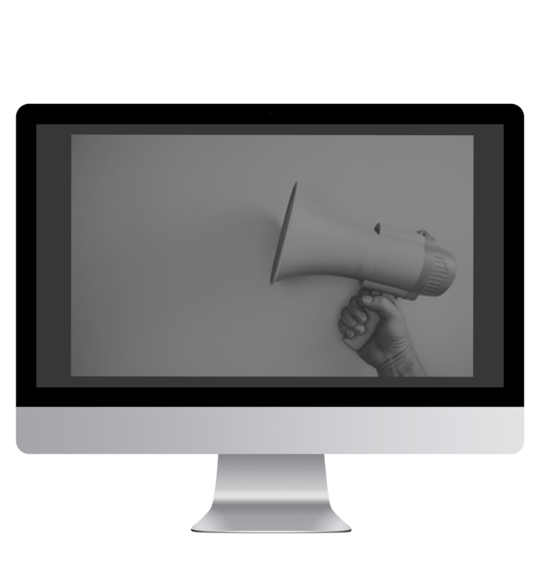 a person holding a megaphone in front of a monitor