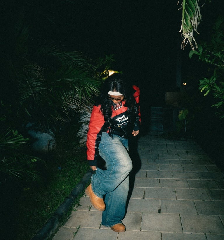 A person walks forward from a darker space into a brighter area, suggesting movement and transition 