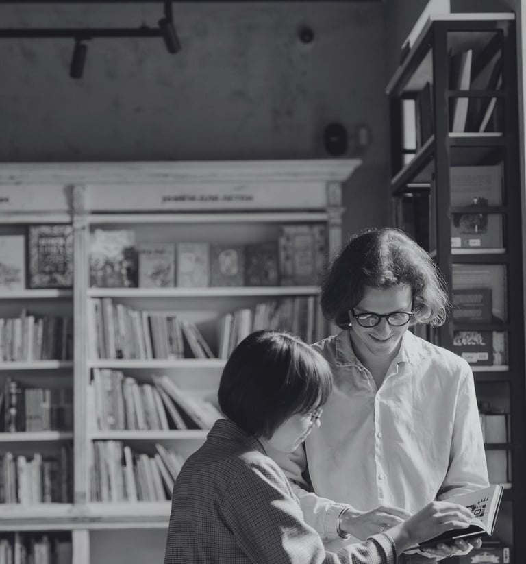 a man and woman standing in a bookshop after connecting on piano piano
