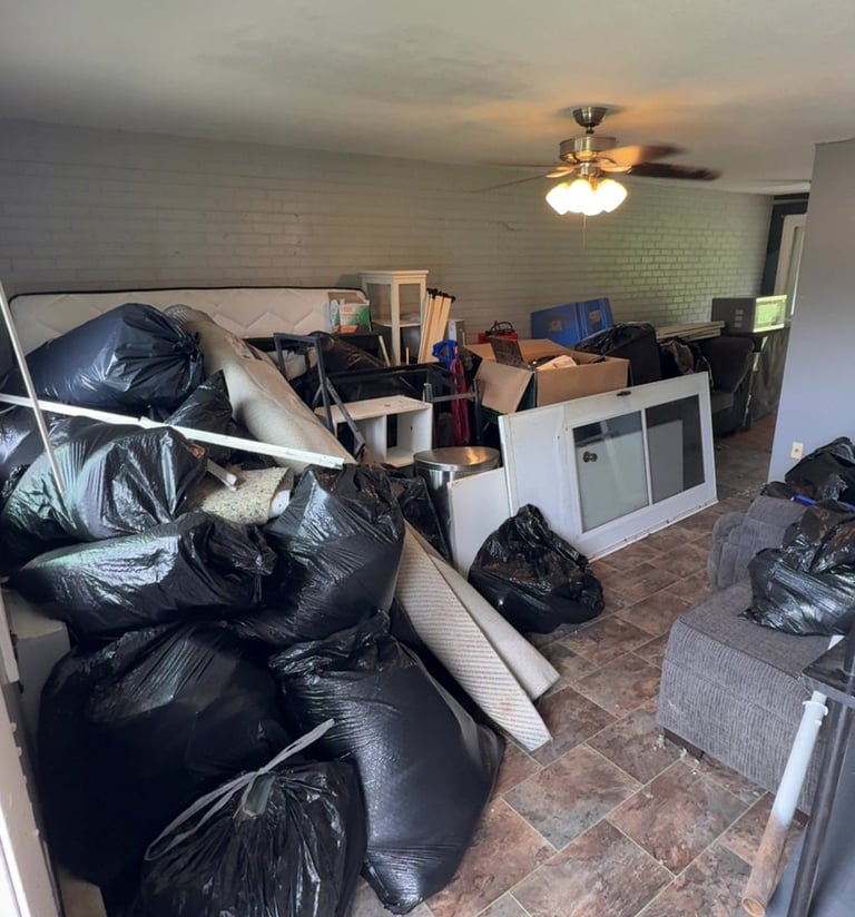 Apartment filled with furniture and clutter before junk removal cleanout