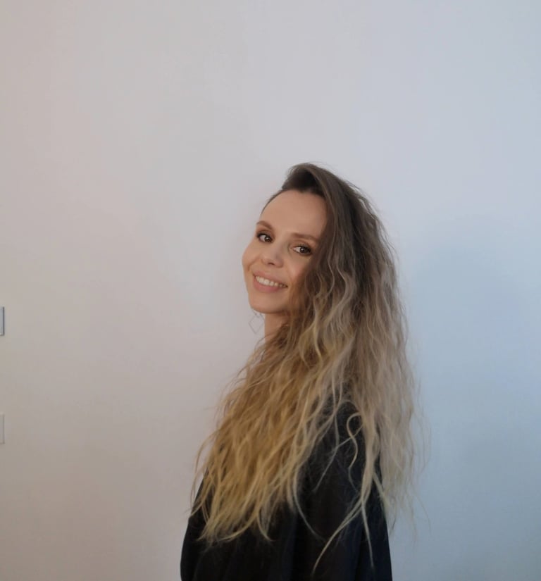 Christine Hauser, certified RTT Practitioner, smiling in a relaxed portrait against light background