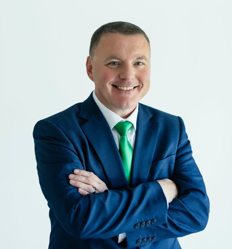 Shawn Kaeser in a suit and tie smiling