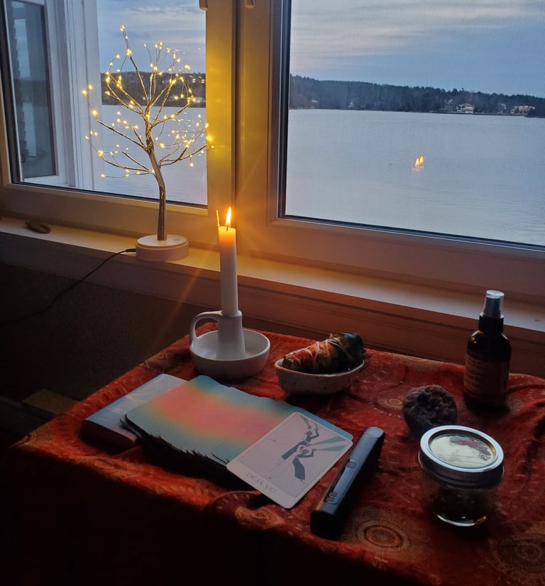 An altar ready for a psychedelic therapy session, with sage, a candle burning and oracle cards