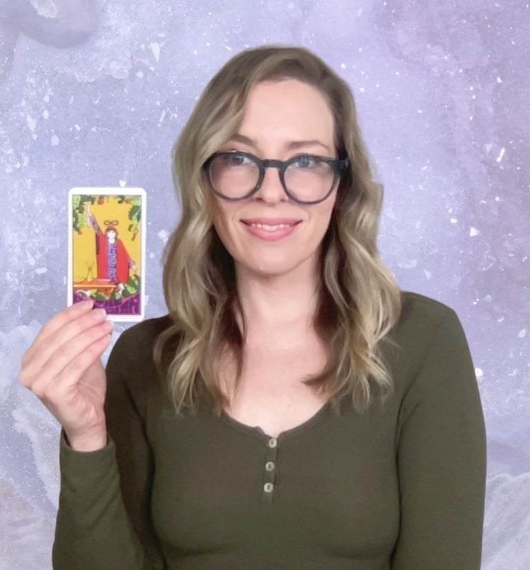 Natalie holding The Magician tarot card for a Crystal Aura Tarot reading.