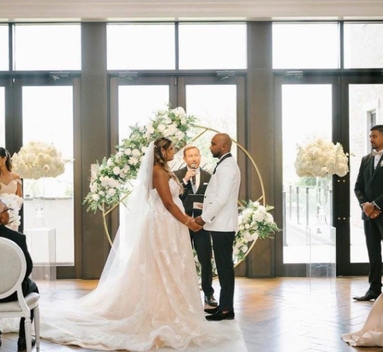 a bride and groom standing in front of a wedding ceremony