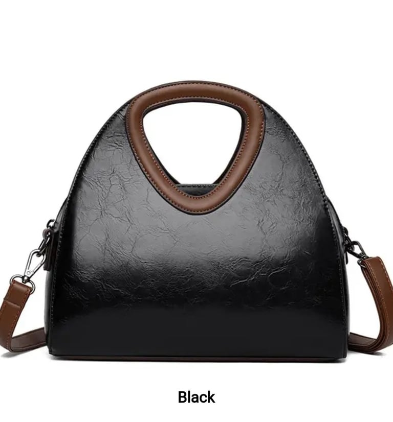 a black and white handbag with a brown leather handbag