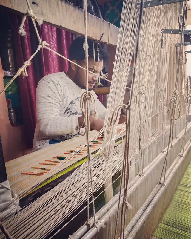 a man is working on a weaving machine