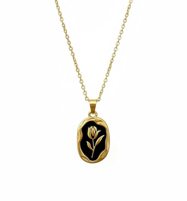 Elegant black gold tulip pendant necklace featuring a black enamel oval charm on a gold chain.
