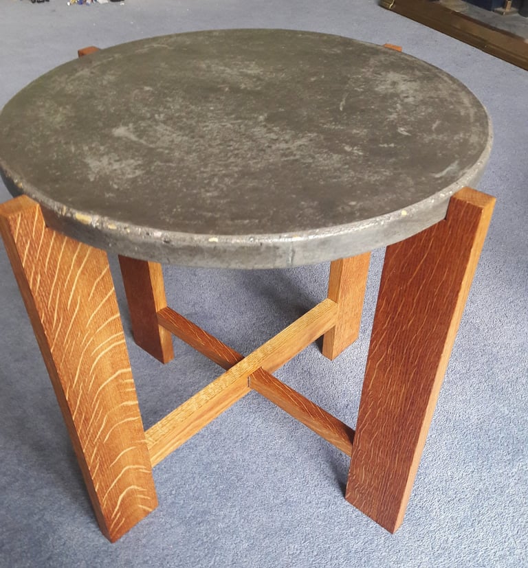 Coffee table made from 4 oak legs with cross pieces topped with a circular concrete top