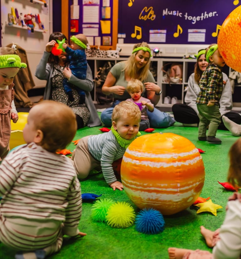 a group of mini moo children playing with toys for space week.