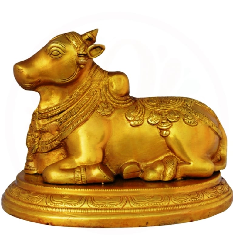 a golden cow statue of a cow in a golden color