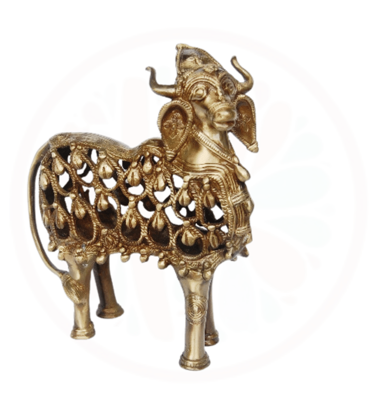 a gold colored metal animal statue of a goat