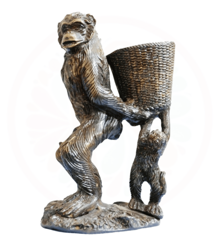 a statue of a monkey holding a basket with a basket
