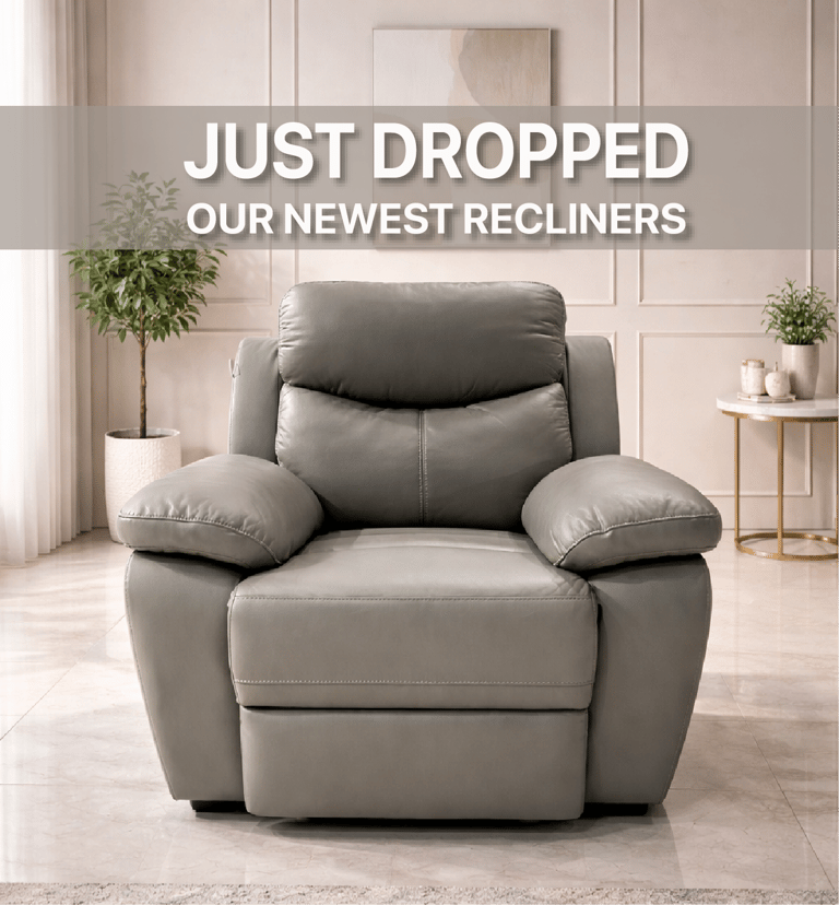 Modern grey leather recliner armchair in a bright living room with neutral decor.