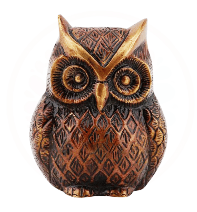 a decorative owl figurine with a gold colored brass owl
