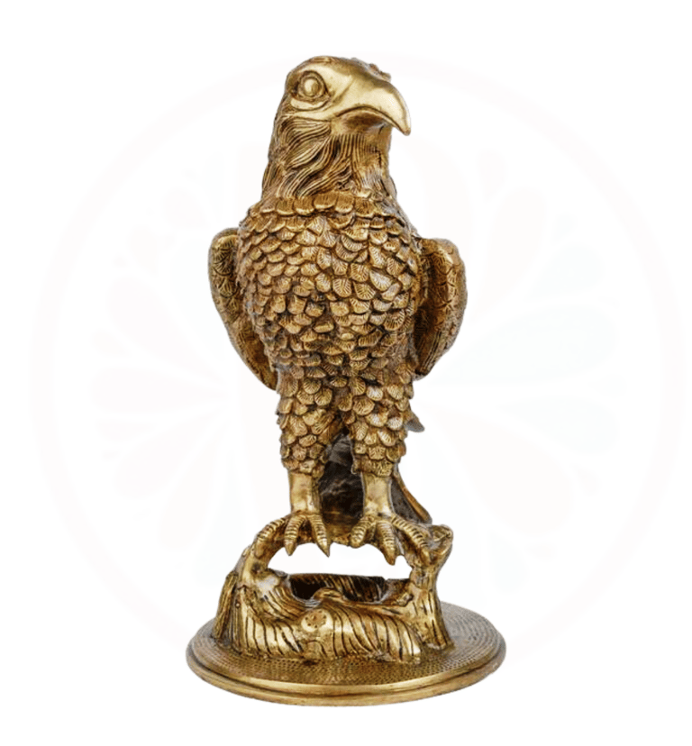 a golden eagle sitting on a pedestal with a gold colored eagle